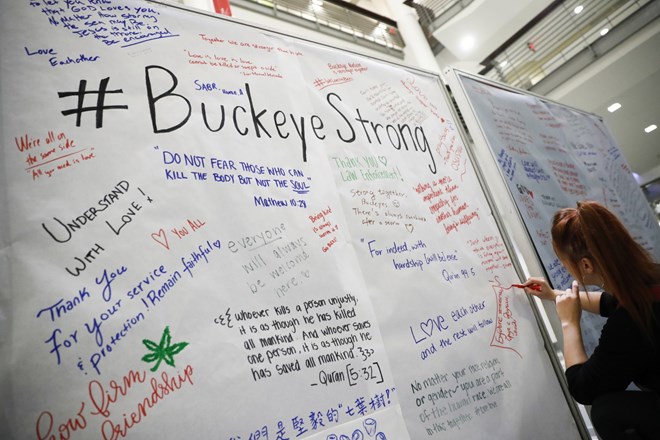 Student Ashley Greivenkamp signs a community message board at the Ohio State University student union on Nov. 29 following an attack on campus the previous day, in Columbus, Ohio. (John Minchillo/Associated Press)