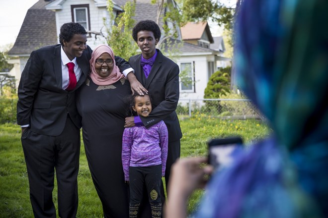 Mohamed Hassan posed for a picture with his mother Amino, brother Ali Hassan and little sister Nhimo Guled before going to his senior prom on May 6, 2017 at home in Columbia Heights, Minn. His sister Fardowsa Hassan took the picture. Renee Jones Schneider