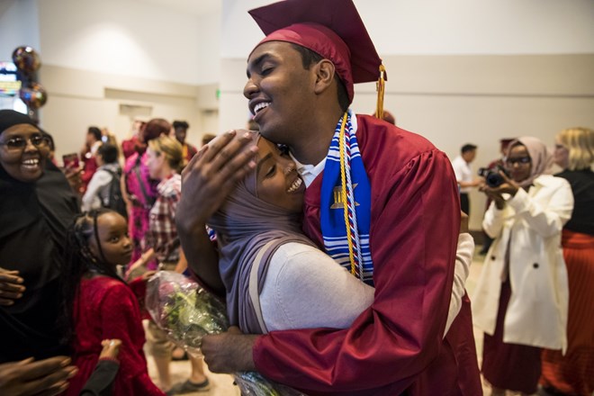 Mohamed Hassan hugged his older sister Ifrah Hassan as he was surrounded by family members after his graduation ceremony on June 8, 2017 at the Minneapolis Convention Center in Minneapolis, Minn. Renee Jones Schneider