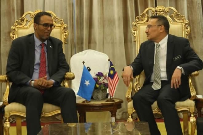 Hishammuddin (right) and Mohamed Omer during a meeting at Parliament on Tuesday.
