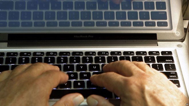 FILE - Hands type on a computer keyboard in Los Angeles, Feb. 27, 2013.