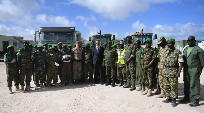David Concar, the UK Ambassador to Somalia, Lt. Gen. Jim Beesigye Owoyesigire, the African Union Mission in Somalia (AMISOM) Force Commander and other AMISOM senior officers pose for a group photo during handing over vehicles donated by the UK Government to AMISOM senior officials in Mogadishu on June 30, 2018. AMISOM Photo / Ilyas Ahmed