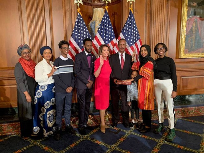 House Speaker Nancy Pelosi of Calif., second from left, poses during a ceremonial swearing-in with Rep. Ilhan Omar, D-Minn., second from right, on Capitol Hill in Washington, Jan. 3, 2019.